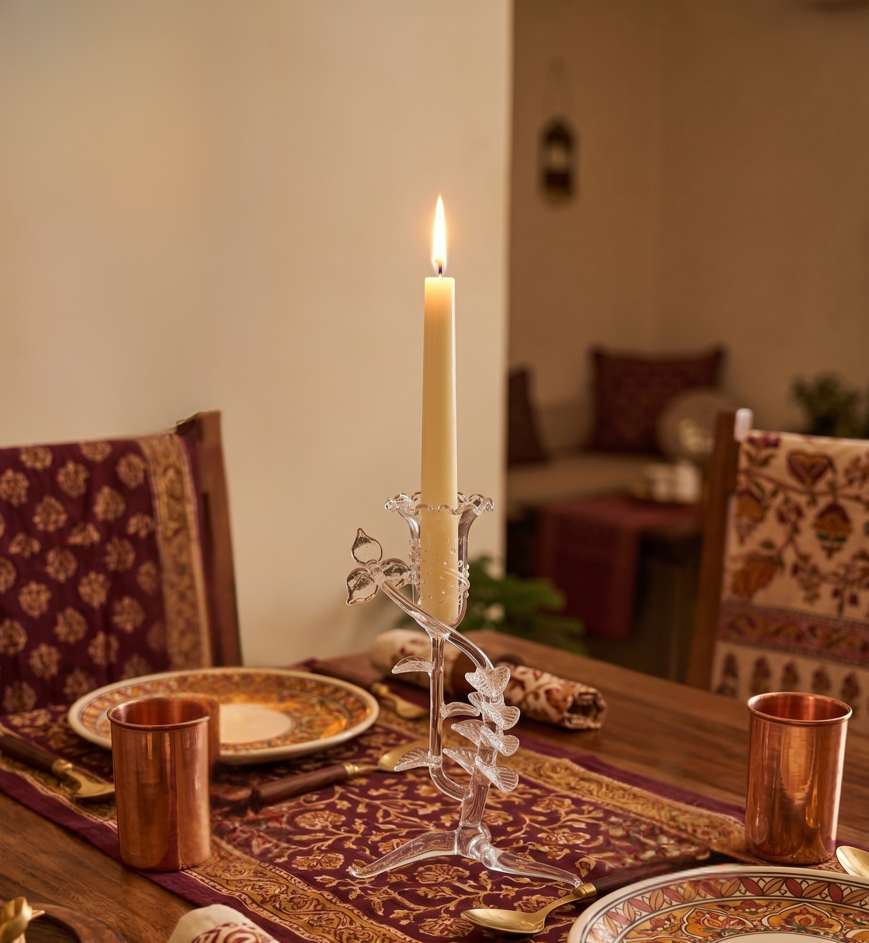 Floral glass candle holder on dining table