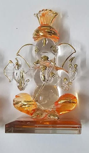 Decorative glass statue of Ganesha with gold accents